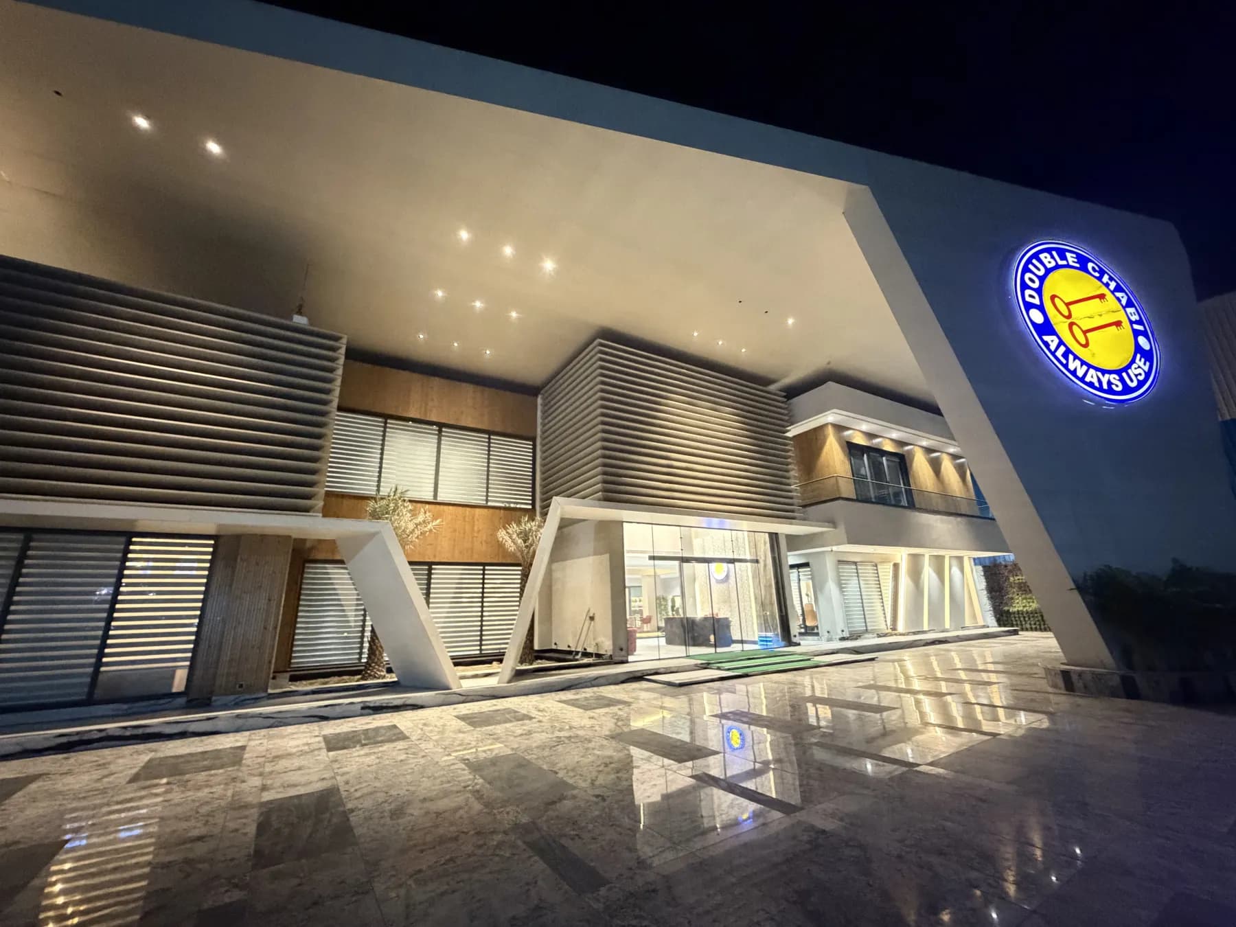 The illuminated frontage of the facility at night.